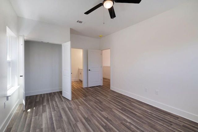 unfurnished bedroom with visible vents, a ceiling fan, baseboards, and dark wood-style flooring