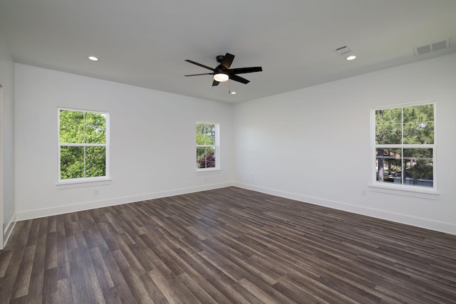spare room featuring recessed lighting, dark wood-style floors, visible vents, a ceiling fan, and baseboards