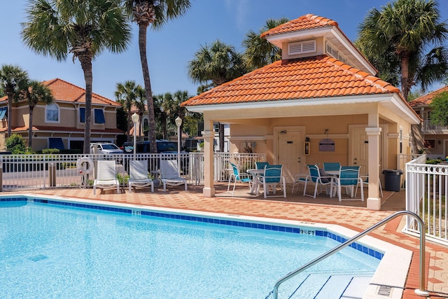 pool featuring fence, a patio area, and a gazebo