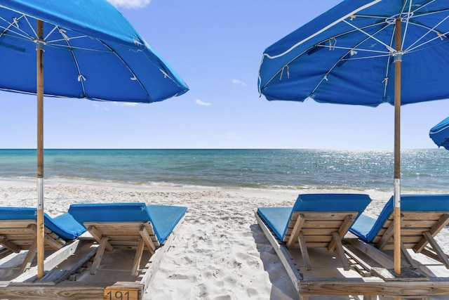 view of patio featuring a beach view and a water view