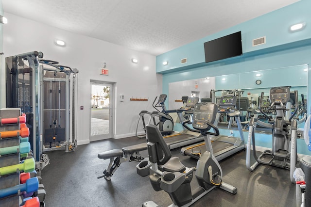 gym with visible vents and a textured ceiling