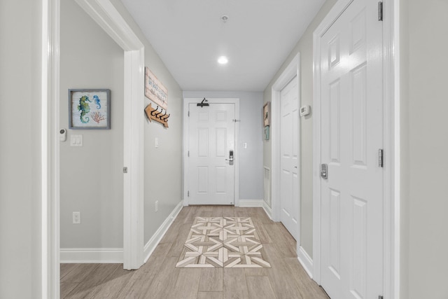 doorway featuring visible vents, light wood-style flooring, baseboards, and recessed lighting