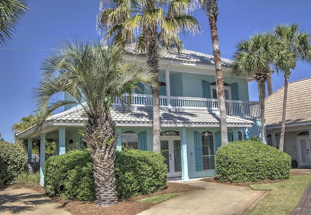 38 Aquamarine Cv, Miramar Beach, FL 32550 - view of front facade with a tile roof, a balcony, and stucco siding