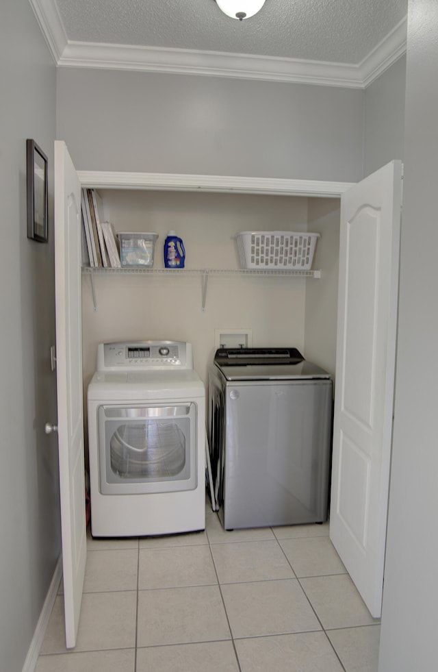 38 Aquamarine Cv, Miramar Beach, FL 32550 - washroom featuring light tile patterned flooring, crown molding, washer and clothes dryer, and laundry area