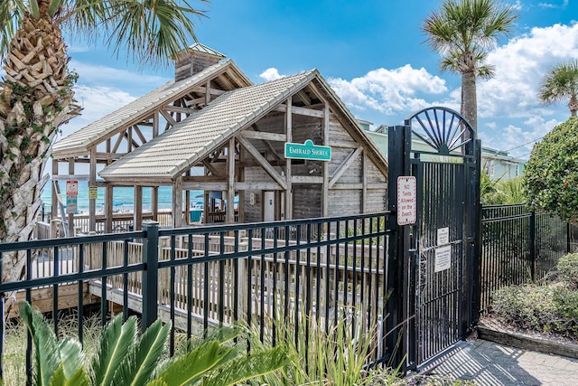 38 Aquamarine Cv, Miramar Beach, FL 32550 - exterior space featuring a gate, a chimney, and fence
