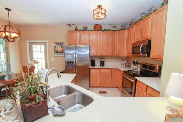 kitchen with decorative light fixtures, appliances with stainless steel finishes, a sink, light countertops, and a notable chandelier