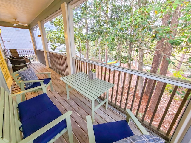 wooden deck featuring ceiling fan