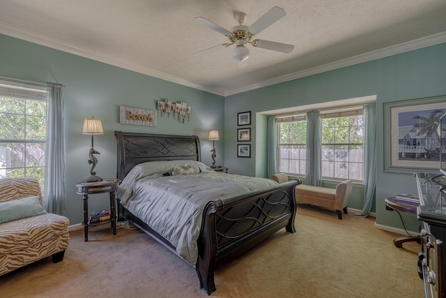 bedroom with carpet flooring, crown molding, baseboards, and ceiling fan