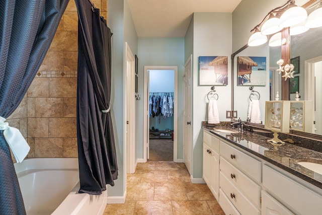 full bathroom featuring shower / bath combo, double vanity, baseboards, and a sink