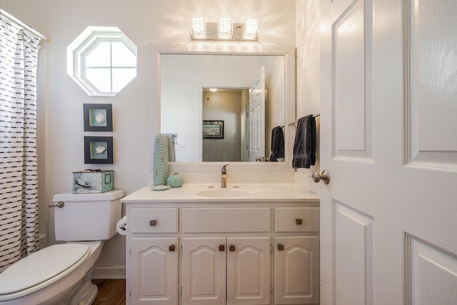 full bathroom with vanity, a shower with shower curtain, and toilet