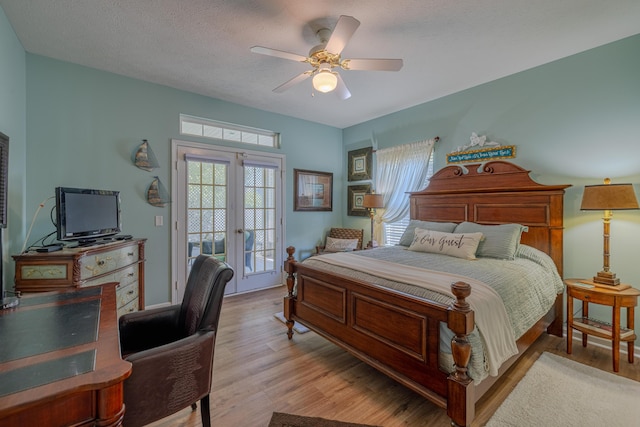 bedroom featuring light wood-type flooring, a textured ceiling, ceiling fan, and access to outside