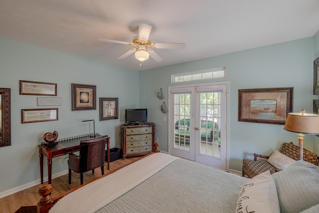bedroom featuring wood finished floors, access to exterior, a ceiling fan, french doors, and baseboards