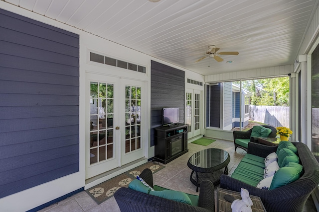 sunroom / solarium with french doors, ceiling fan, and an outdoor living space