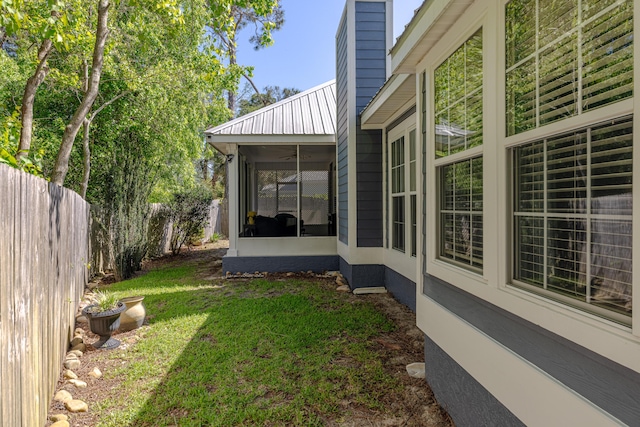 view of yard featuring a sunroom and a fenced backyard