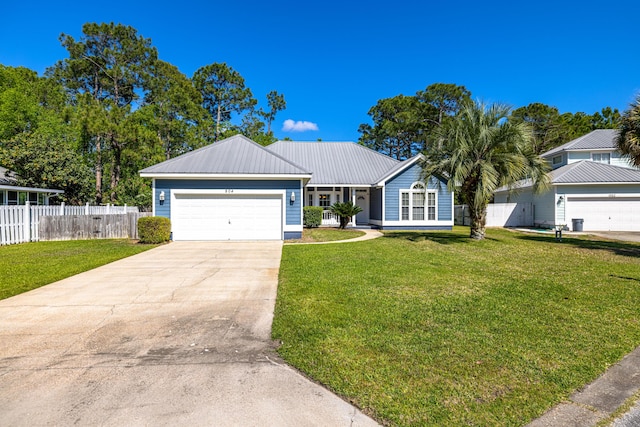 ranch-style home with concrete driveway, a front lawn, fence, and metal roof