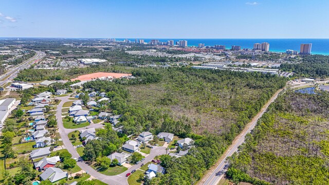 birds eye view of property with a view of city and a water view