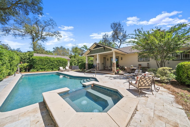 view of swimming pool featuring a pool with connected hot tub and a patio