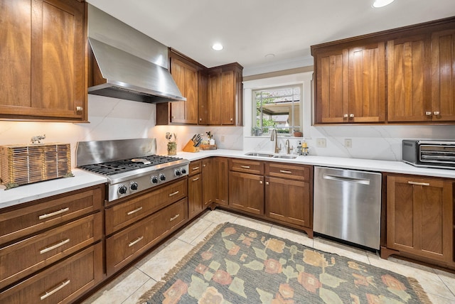 kitchen with a sink, light tile patterned floors, a toaster, wall chimney exhaust hood, and appliances with stainless steel finishes
