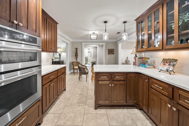 kitchen featuring a peninsula, light tile patterned flooring, stainless steel double oven, glass insert cabinets, and decorative light fixtures