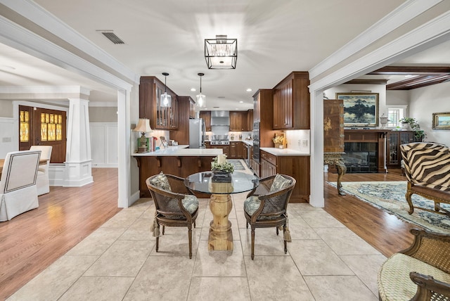 dining room featuring recessed lighting, visible vents, light tile patterned flooring, decorative columns, and a glass covered fireplace