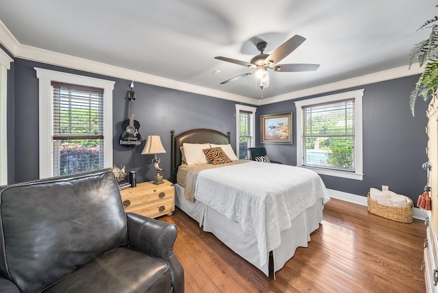 bedroom featuring ornamental molding and multiple windows