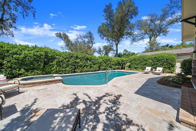 view of pool featuring a patio area and a pool with connected hot tub