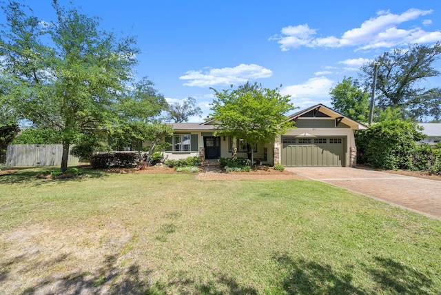 view of front of house with an attached garage, a front lawn, fence, and decorative driveway
