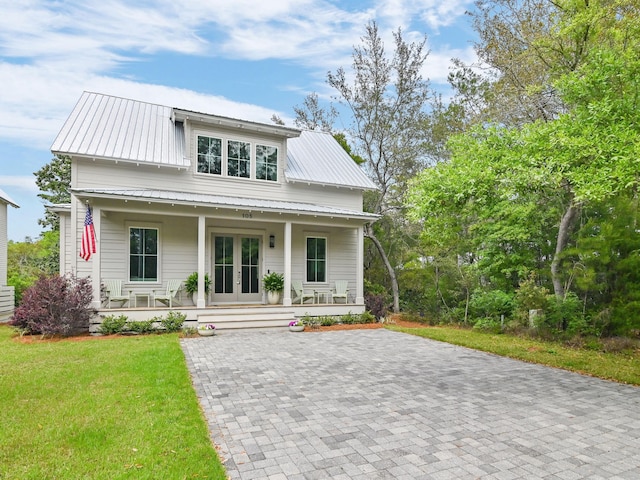 105 Greenbriar Ln, Santa Rosa Beach, FL 32459 - bungalow featuring french doors, a porch, a front yard, and metal roof