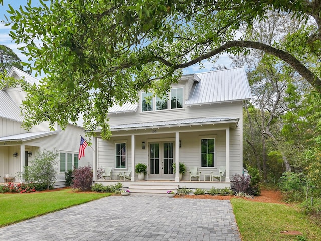 105 Greenbriar Ln, Santa Rosa Beach, FL 32459 - view of front of home featuring covered porch, metal roof, french doors, and a front lawn