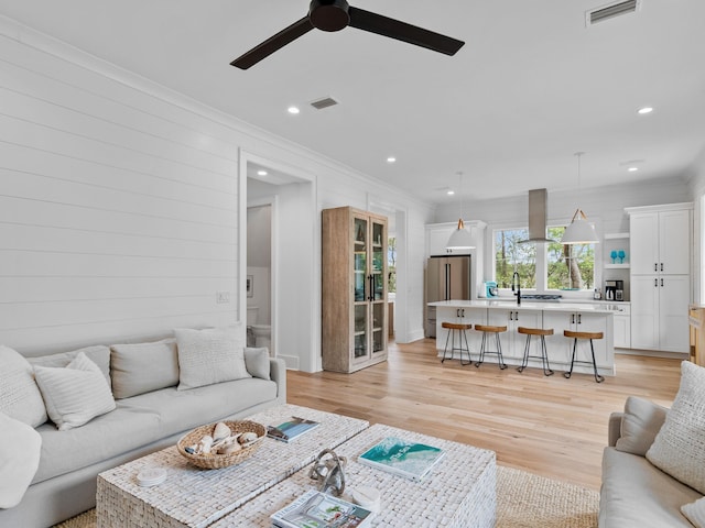 105 Greenbriar Ln, Santa Rosa Beach, FL 32459 - living area with visible vents, light wood finished floors, and crown molding