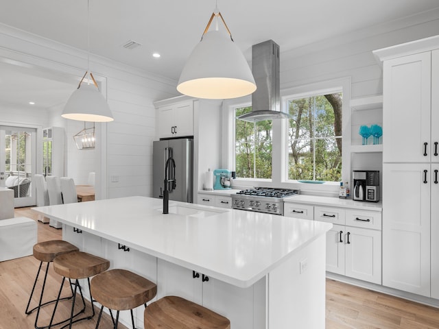 105 Greenbriar Ln, Santa Rosa Beach, FL 32459 - kitchen featuring visible vents, freestanding refrigerator, white cabinets, island exhaust hood, and light wood-type flooring