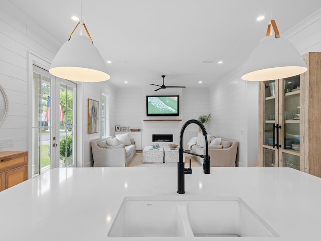 105 Greenbriar Ln, Santa Rosa Beach, FL 32459 - kitchen featuring a ceiling fan, open floor plan, a fireplace, and a sink