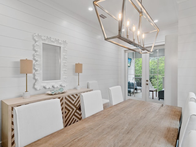 105 Greenbriar Ln, Santa Rosa Beach, FL 32459 - dining space with visible vents, an inviting chandelier, and wood walls