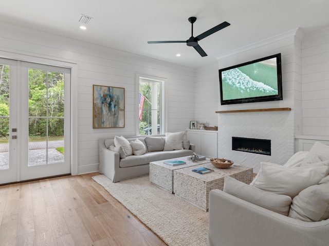 105 Greenbriar Ln, Santa Rosa Beach, FL 32459 - living room featuring ceiling fan, visible vents, light wood-type flooring, ornamental molding, and a fireplace