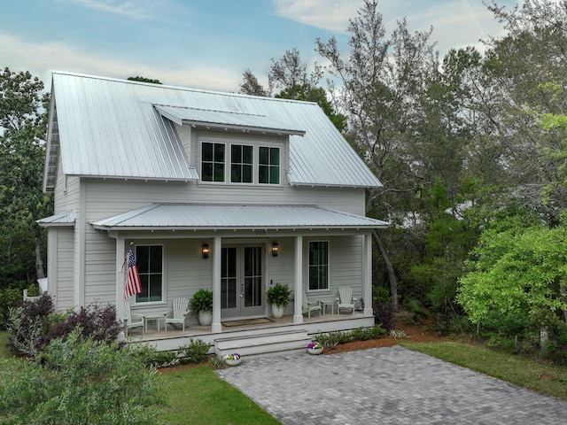 105 Greenbriar Ln, Santa Rosa Beach, FL 32459 - view of front facade featuring covered porch, french doors, and metal roof