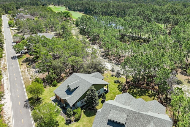 drone / aerial view featuring a view of trees
