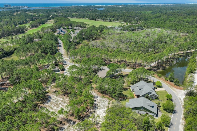 bird's eye view with a forest view and a water view