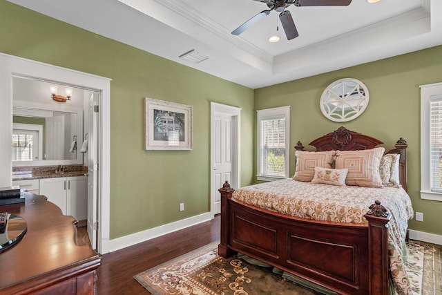 bedroom featuring a raised ceiling, visible vents, baseboards, and multiple windows