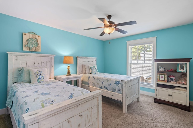 bedroom with ceiling fan, light carpet, and baseboards
