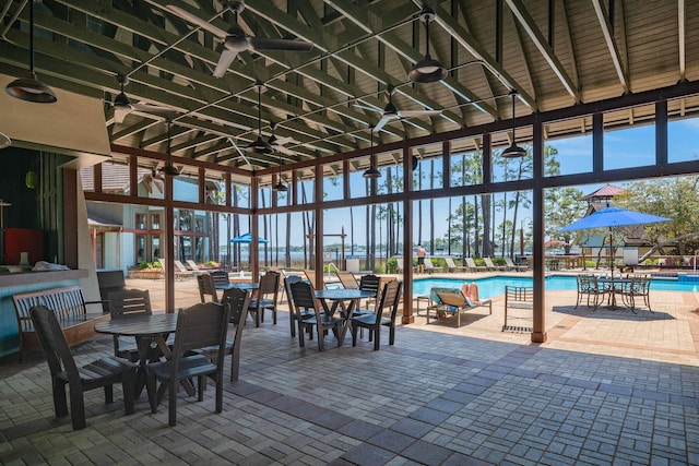 exterior space with ceiling fan and a community pool