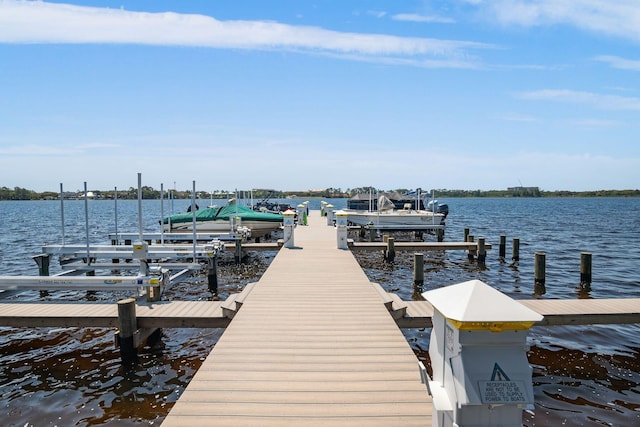 view of dock with boat lift and a water view