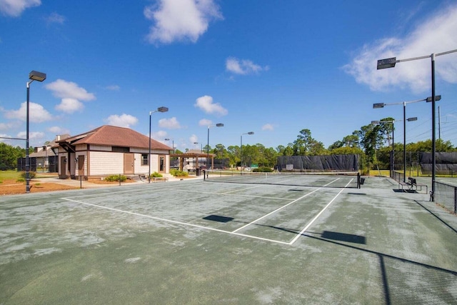 view of sport court featuring fence