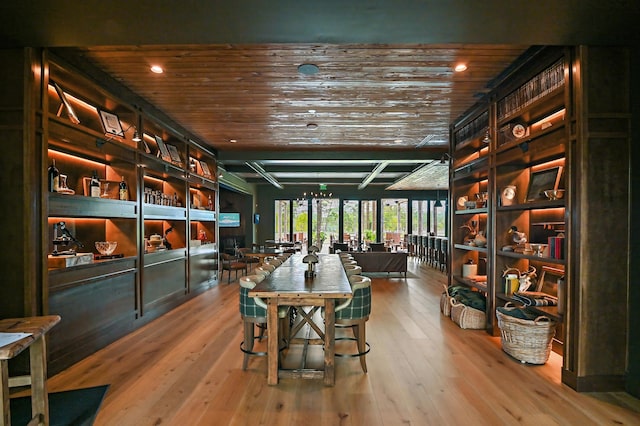 interior space featuring hardwood / wood-style floors, wooden ceiling, and recessed lighting