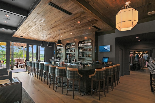 bar featuring recessed lighting, hardwood / wood-style floors, visible vents, wooden ceiling, and a community bar