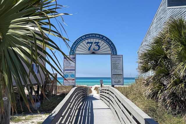 surrounding community featuring a view of the beach and a water view