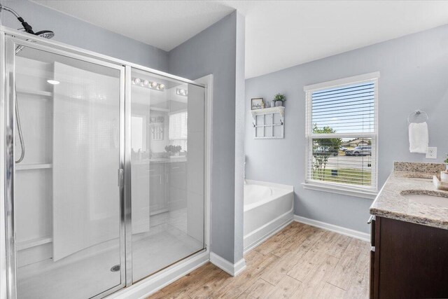 3129 Partridge Dr, Crestview, FL 32539 - full bathroom featuring a shower stall, a garden tub, wood finished floors, and double vanity