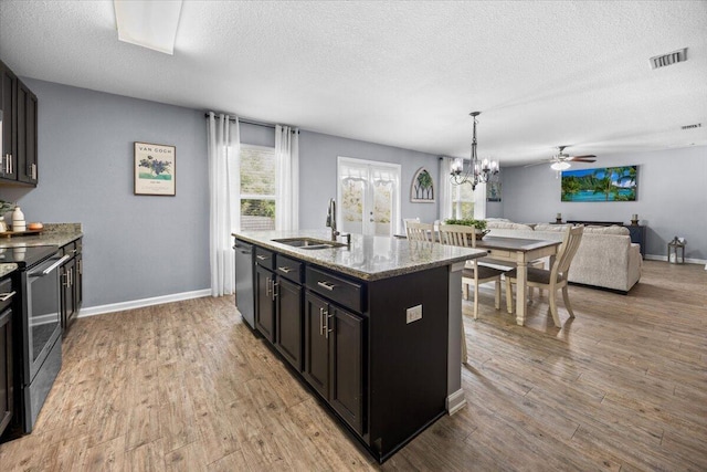 3129 Partridge Dr, Crestview, FL 32539 - kitchen featuring range with electric cooktop, a sink, black dishwasher, a textured ceiling, and open floor plan