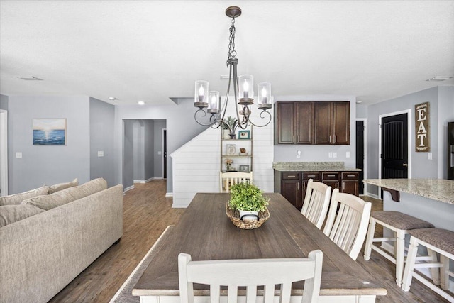 3129 Partridge Dr, Crestview, FL 32539 - dining space featuring stairs, baseboards, a chandelier, and dark wood-style flooring