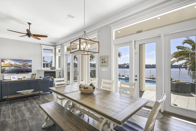 4720 Rendezvous Cv, Destin, FL 32541 - dining space featuring wood finished floors, ornamental molding, a fireplace, recessed lighting, and a chandelier