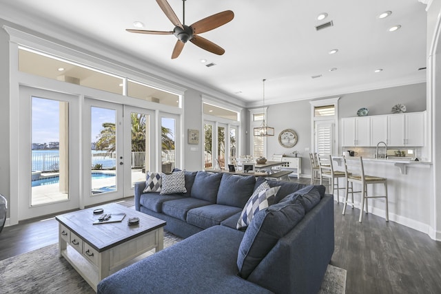 4720 Rendezvous Cv, Destin, FL 32541 - living room featuring french doors, ornamental molding, dark wood-style flooring, a ceiling fan, and recessed lighting